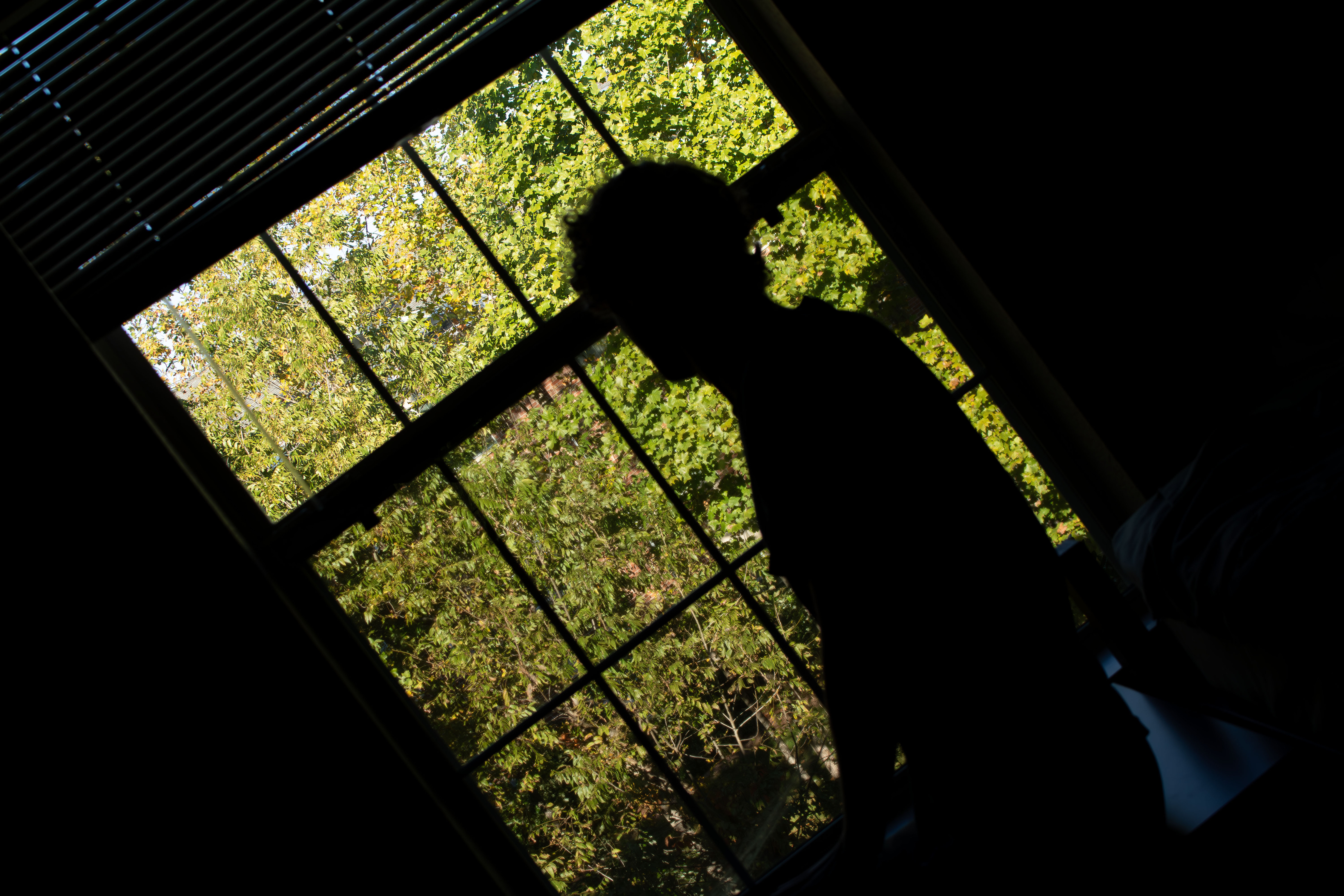 Silhouette looking out window